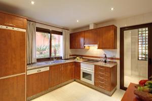 a kitchen with a stove top oven and a sink at Vasari Resort in Marbella