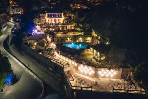 a mansion with a swimming pool at night at Hotel Villa Margherita in Quercianella
