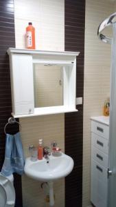 a bathroom with a white sink and a mirror at Apartman Jevtić 2 in Gornja Toplica