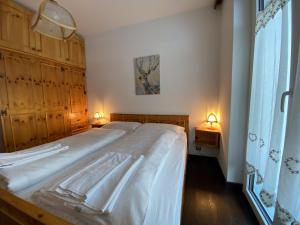 Posteľ alebo postele v izbe v ubytovaní Appartamento Cuore by AMA Val di Fassa
