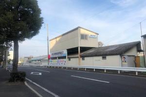a building on the side of a road next to a street at 玉藻本町101 in Takamatsu