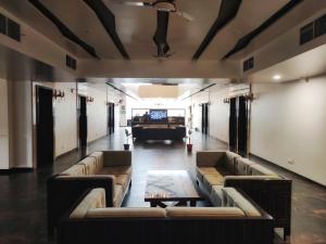 a large living room with couches and a tv at Hotel Grand Kaushalya in Sohāgpur