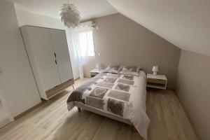 una camera bianca con un letto e una finestra di appartement maison en duplex 80m² jardin terrasse a Saint-Julien-les-Villas