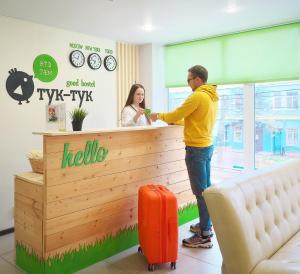 a man standing at a counter in a waiting room at Тук Тук Хостел in Yaroslavl