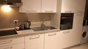a kitchen with a sink and a washing machine at Berga Exclusive Suite 4 in Bari