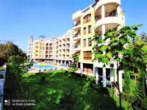 a large building with a lawn in front of it at Diamond Palace in Sunny Beach
