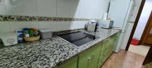 a kitchen with a sink and a counter top at Casa Puerta de la Victoria in Córdoba +23 photos