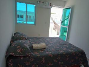 a bedroom with a bed with a purse on it at Duplex Paraíba Litoral Sul Jacumã Acesso as Melhores Praias do Brasil in Jacumã