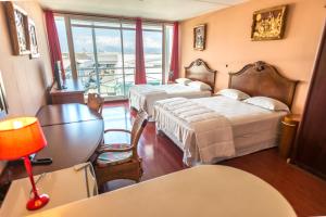 Postel nebo postele na pokoji v ubytování Hotel Sarah Nui