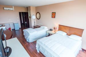 Postel nebo postele na pokoji v ubytování Hotel Sarah Nui