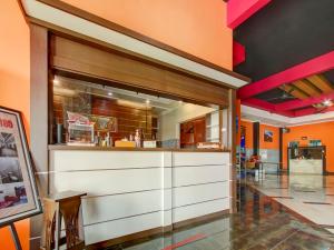 a kitchen with white cabinets and a large window at Super OYO Capital O 90151 Guest House 180 in Batu