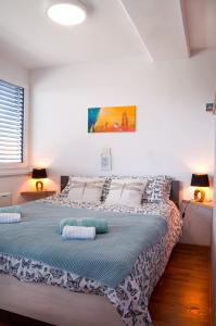 a bedroom with a large bed with two pillows on it at Sea Sun & Me Apartment in Koper