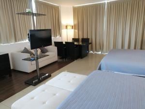 a hotel room with a bed and a tv at Town Center Playa Blan in Playa Blanca