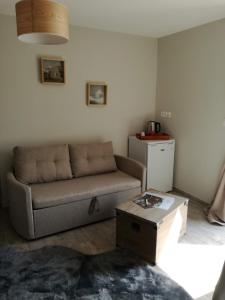 a living room with a couch and a coffee table at Naphéo in Tonnay-Charente