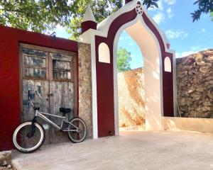 
a bike parked in front of a stone building at Hotel Posada San Juan in Valladolid
