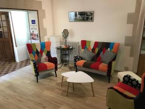 a living room with two chairs and a table at Domaine de Joreau in Gennes