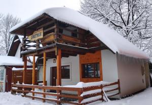 a cabin in the snow with a sign on it at Apartments Life in Kolašin