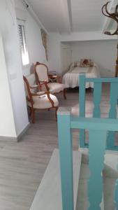 1 dormitorio con 1 cama, mesa y sillas en El Rincón del Abuelo, en Villaviciosa de Córdoba