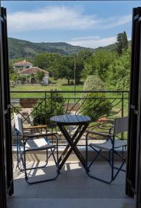 a table and chairs on a balcony with a view at Harmony Seaside Pelion in Platanias