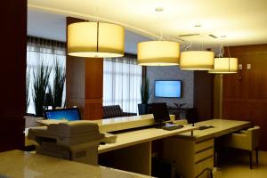 an office with a desk and two chandeliers at Imigrantes Hotel in Santa Rosa