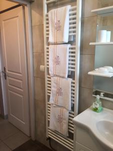 a bathroom with towels on a towel rack next to a sink at Rochire Location 2 in Gérardmer
