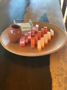 a plate with slices of fruit on a table at Kin Ha Tulum Hotel in Tulum