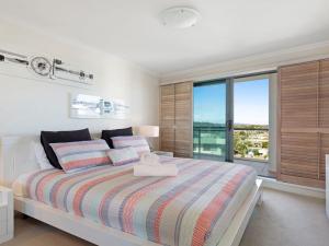 a bedroom with a bed and a large window at Le Point 702 Luxury and Views in Forster
