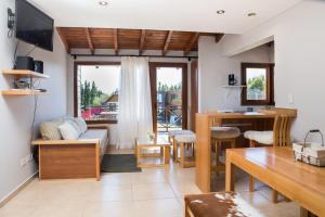 a living room with a couch and a table at Encanto sobre el Nahuel in Dina Huapi