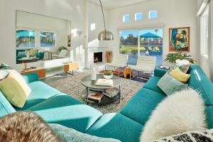 a living room with a blue couch and a table at Casa Agave Palm Springs in Palm Springs