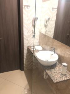 a bathroom with a sink and a glass shower at Отель Лайнер in Khimki