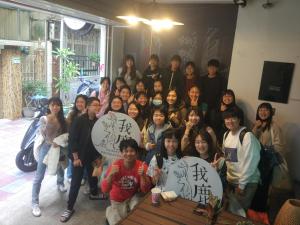 a group of people posing for a picture with umbrellas at mydeer backpacker in Tainan +91 photos