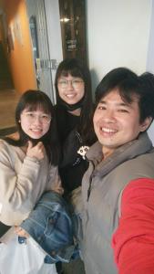 three young people are posing for a picture at mydeer backpacker in Tainan