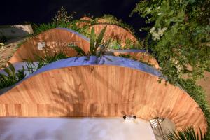 a wooden bench with a plant on top of it at CityHouse VIBE City Oasis in Ho Chi Minh City +57 photos