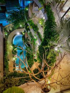 an overhead view of a swimming pool in a garden at Cityhouse - CityOasis in Ho Chi Minh City