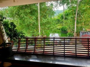 a view of a river from a balcony with a window at Amritham Holidays Homestay Trivandrum in Trivandrum