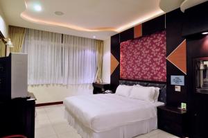 Ένα ή περισσότερα κρεβάτια σε δωμάτιο στο Kenting Motel