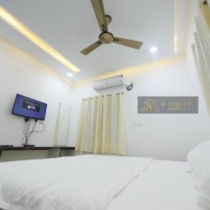 a hospital room with a bed and a ceiling fan at R Square Guest inn in Nellore