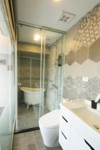 a bathroom with a tub and a toilet and a sink at 阜東樓 in Tainan +35 photos