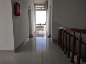 a hallway with a staircase and a stair case at Hung Phuc Mui Ne Hotel in Mui Ne