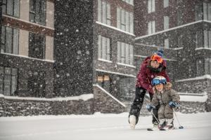 a woman and a child on skis in the snow at Yu Kiroro, Ski-in Ski-out Luxury Residences in Akaigawa