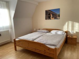 1 dormitorio con cama de madera en una habitación en Fewo Haus Piepenbreier, en Bad Sassendorf