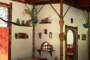 a room with a wall with many items on it at Cascata Del Bosco Cabinas in San Vito