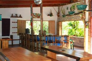 a dining room with a wooden table and chairs at Cascata Del Bosco Cabinas in San Vito