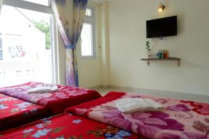 A bed or beds in a room at Tuan Vu Hai Dang Da Lat