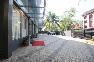 a red rug on a sidewalk next to a building at Hotel Vemara in Panaji