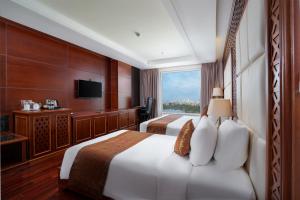 Giường trong phòng chung tại Samdi Da Nang Central Hotel