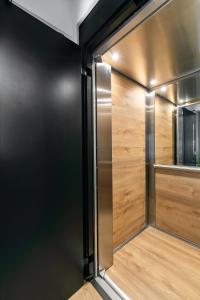 a walk in closet with wooden doors and a mirror at δ193 in Volos