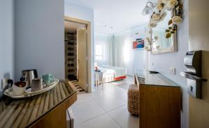 a kitchen with a counter and a room with a bed at Bat Galim Boutique Hotel in Haifa