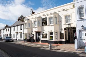 a white building with a sign on it on a street at Worthing bright and cosy double room in Worthing