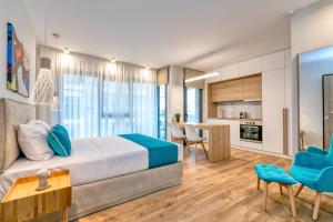 a bedroom with a large bed and a kitchen at δ193 in Volos